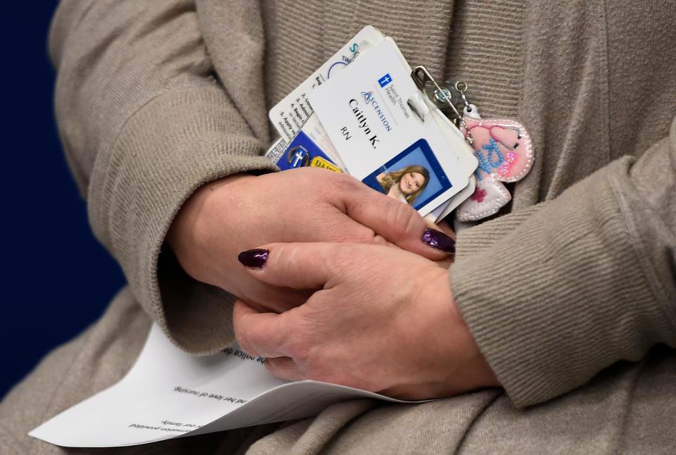 Diane Kaufman holds her daughter’s St. Thomas West hospital work badge during a Metro Nashville Police Department press conference on Dec. 7, 2020.