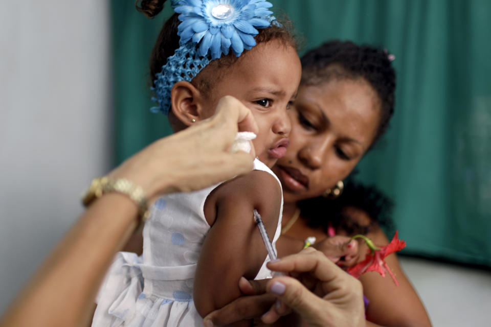 In this Aug 10, 2012 photo, a nurse gives Karolin Deniss Verdecia a shot for allergies at a government run neighborhood clinic in Havana, Cuba. Cuba's system of free medical care, long considered a birthright by its citizens and trumpeted as one of the communist government's great successes, is not immune to cutbacks under Raul Castro's drive for efficiency. The health sector has already endured millions of dollars in budget cuts and tens of thousands of layoffs, and Castro is looking for more ways to save. (AP Photo/Franklin Reyes)