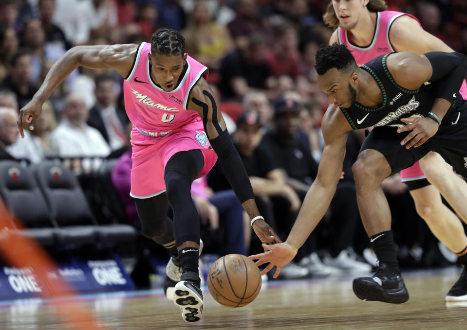 Miami Heat guard Josh Richardson (0) and Minnesota Timberwolves guard Josh Okogie go for a loose ball during the first half of an NBA basketball game, Sunday, Dec. 30, 2018, in Miami. (AP Photo/Lynne Sladky)