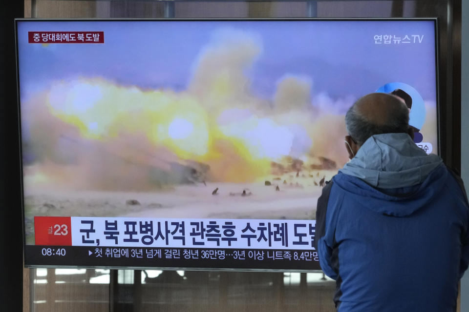 A TV screen shows a file image of North Korea's military exercise during a news program at the Seoul Railway Station in Seoul, South Korea, Wednesday, Oct. 19, 2022. North Korea fired artillery shells near its sea boundaries with South Korea late Tuesday, a day after the South began annual military drills to better deal with North Korean provocations. (AP Photo/Ahn Young-joon)