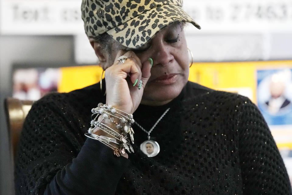 Bernice Ringo wipes her eye during an interview, Tuesday, March 28, 2023, in Detroit. Ringo had plans to move to Alabama with her son to get him away from the crime she had feared most of his life. But those plans crumbled in 2019 when Natalian, 23, was fatally shot while sitting in his parked car. Ringo's application for compensation was ultimately denied because police believed her son had contributed to his murder. (AP Photo/Carlos Osorio)