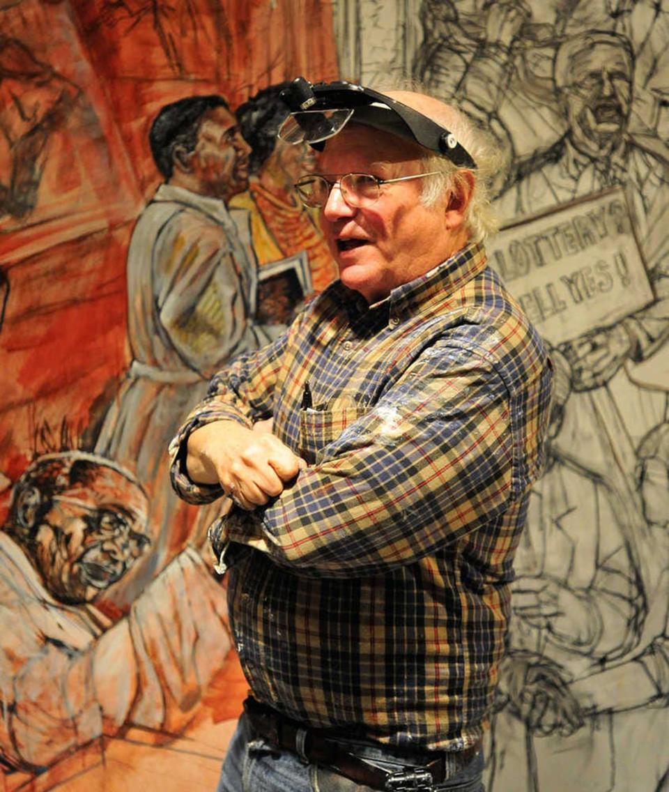 FILE - This photo dated Jan. 17, 2012 shows Art Rosenbaum working on a mural for the Special Collections Library at the University of Georgia. Rosenbaum passed away on Sept. 4, 2022 at age 83.