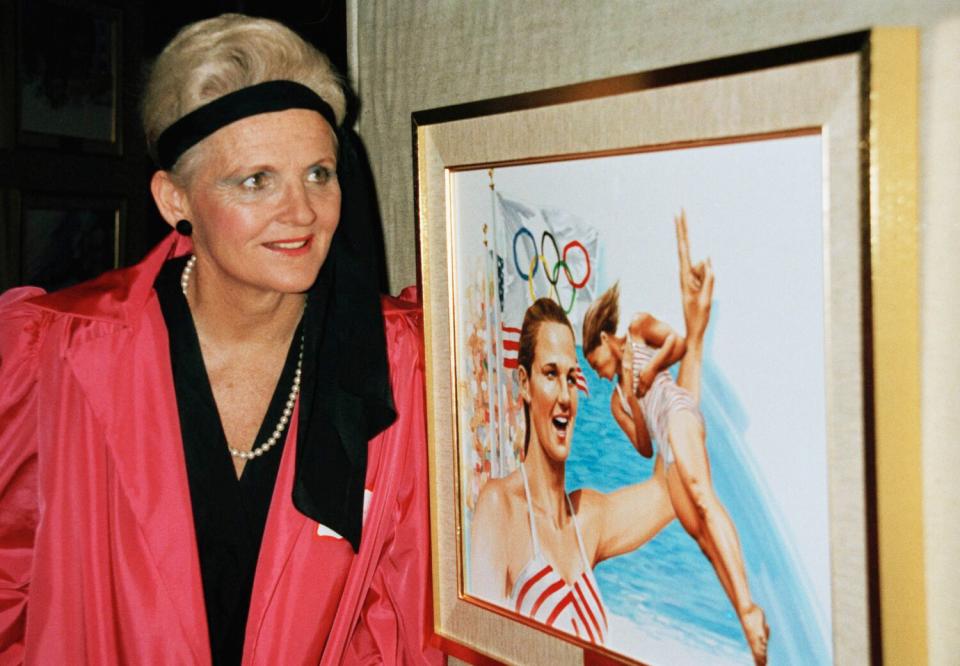 Pat McCormick stands in front of artwork depicting her Olympic feats.