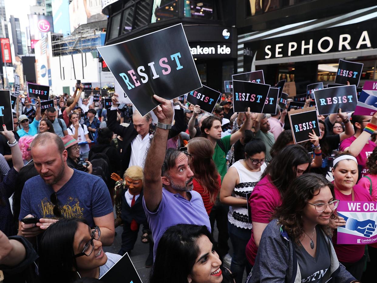 Protesters in New York last year demonstrating at President Trump's decision to reinstate a ban on transgender people serving in the military: Getty