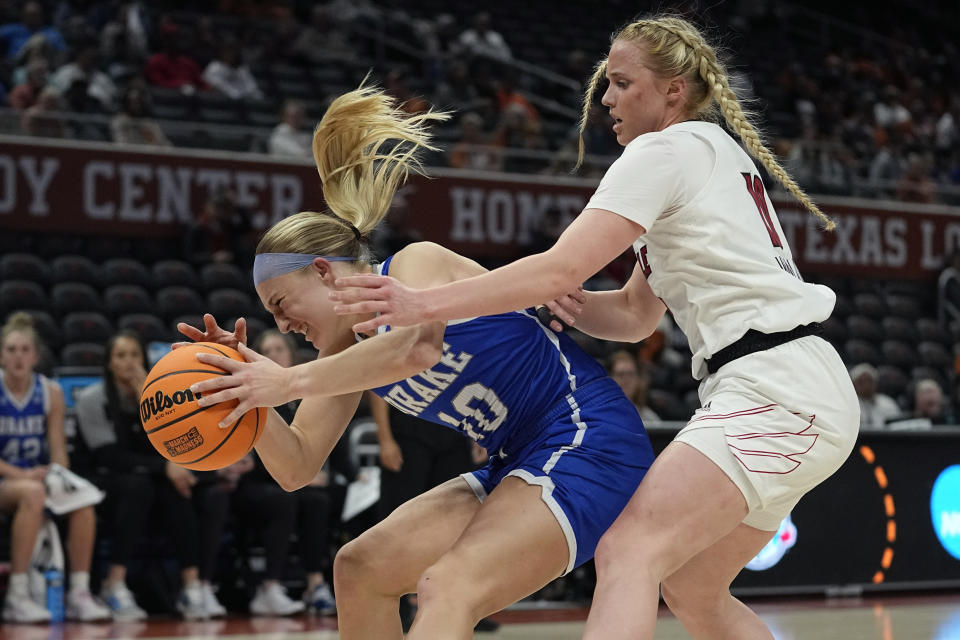 Drake guard Katie Dinnebier, left, grabs a loose ball in front of Louisville guard Hailey Van Lith (10) during the first half of a first-round college basketball game in the NCAA Tournament in Austin, Texas, Saturday, March 18, 2023. (AP Photo/Eric Gay)