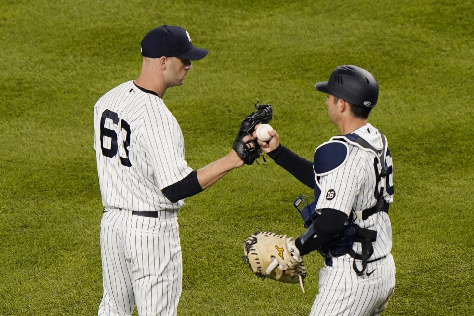 New York Yankees catcher Kyle Higashioka (66) congratulates Yankees relief pitcher Lucas Luetge (63) after the Yankees 7-2 victory over the Baltimore Orioles in a baseball game, Tuesday, April 6, 2021, at Yankee Stadium in New York. Luetge allowed a two-run, home run to Baltimore Orioles Rio Ruiz. (AP Photo/Kathy Willens)