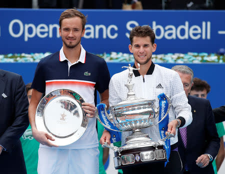 Tennis - ATP 500 - Barcelona Open - Real Club de Tenis Barcelona, Barcelona, Spain - April 28, 2019 Austria's Dominic Thiem celebrates with the trophy after winning the Barcelona Open with runner up Russia's Daniil Medvedev REUTERS/Albert Gea