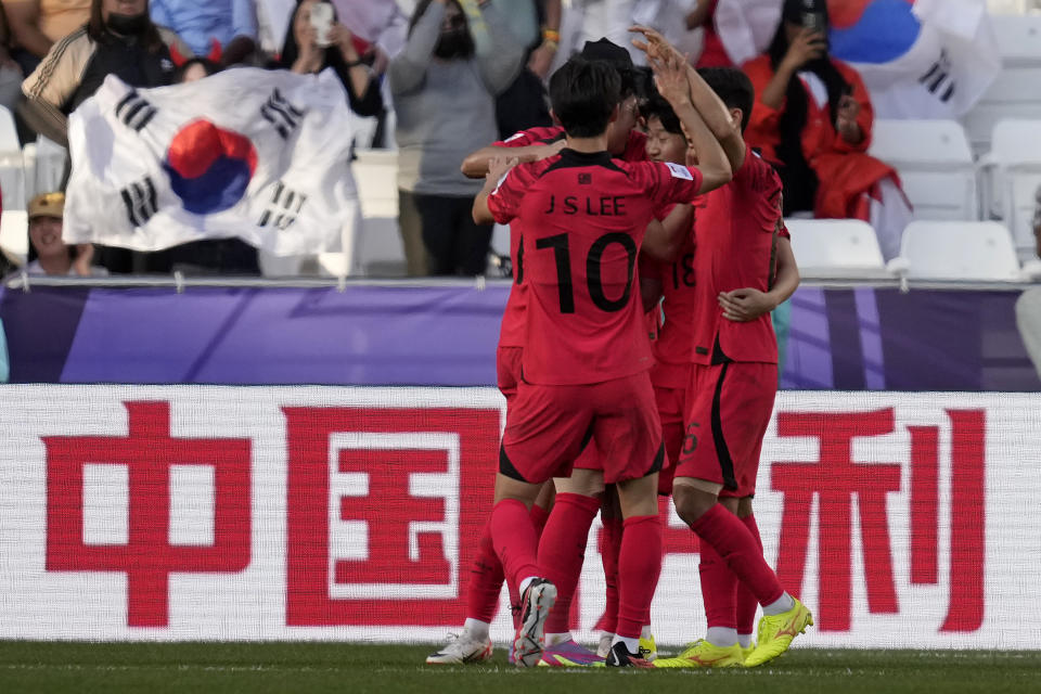 South Korea's Lee Kang-in, second right, celebrates with teammates after scoring his side's third goal during the Asian Cup Group E soccer match between South Korea and Bahrain at Jassim Bin Hamad Stadium in Doha, Qatar, Monday, Jan. 15, 2024. (AP Photo/Thanassis Stavrakis)