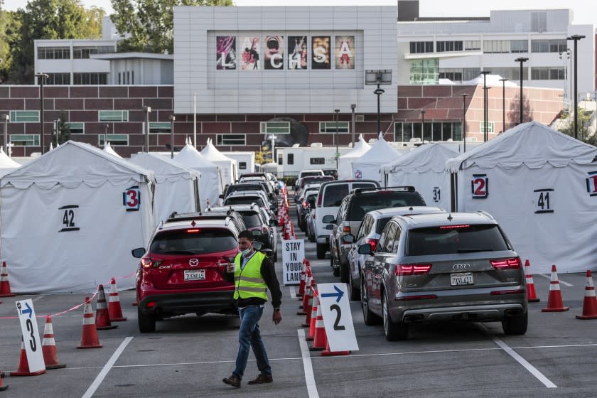 Los Angeles CA, Monday, April 5, 2021 - Drivers line up for Covid-19 vaccines at Cal State LA the day it is announced that 4 million shots have been provided to under served communities. (Robert Gauthier/Los Angeles Times)