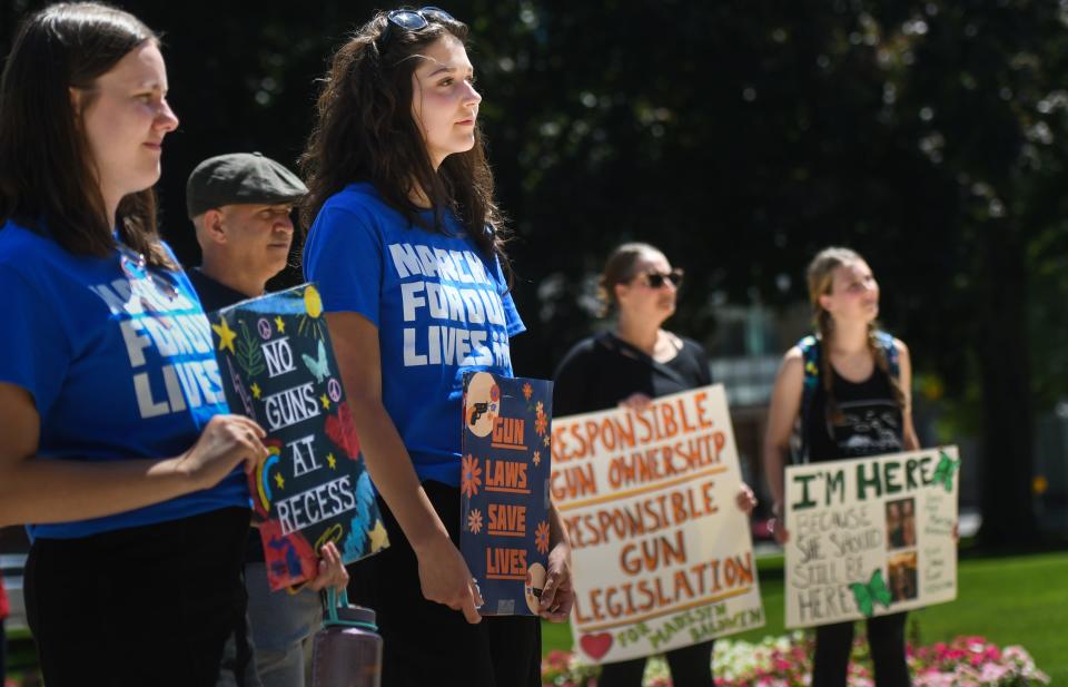 Claire Robinson of Ann Arbor, left, a sophomore at Tufts University in Boston, and Oliva Morelli, a freshman at Indiana University, demonstrate Friday, Aug. 12, 2022, during the "No Guns at Recess" rally at the state Capitol in Lansing. The event was organized by March for Our Lives Michigan.