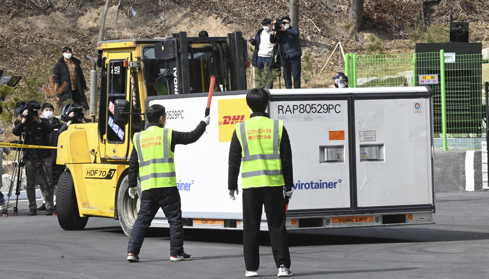 A container containing AstraZeneca's coronavirus vaccines is transported at a distribution center in Icheon, South Korea, Wednesday, Feb. 24, 2021. South Korea's top infectious disease expert has warned that vaccines will not end the coronavirus pandemic quickly as the country prepared to give its first vaccinations this week. (Yonhap via AP)