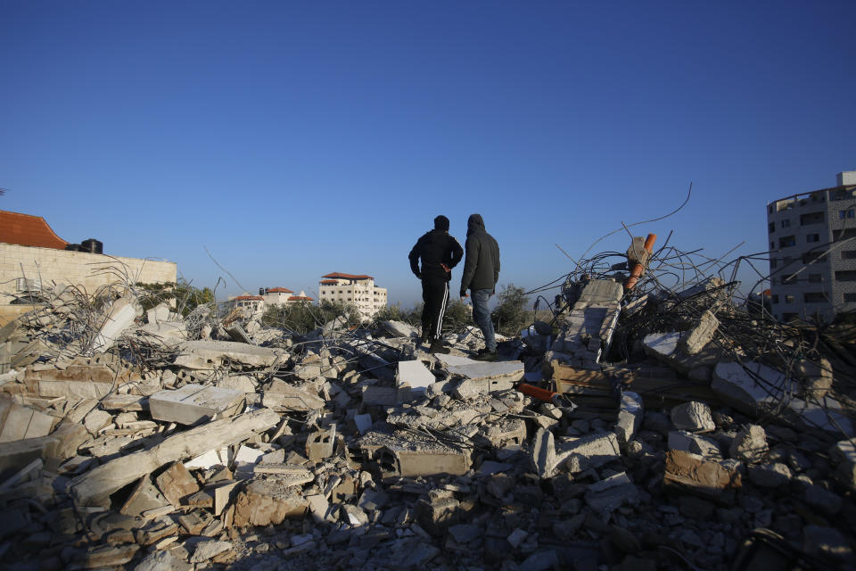 Palestinians inspect a house after it was demolished by the Israeli army in the West Bank city of Jenin, Thursday, Feb. 6, 2020. Israeli military spokesman Lt. Col. Jonathan Conricus said troops were carrying out the demolition of a home belonging to a militant allegedly involved in a deadly attack. (AP Photo/Majdi Mohammed)