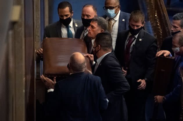 Rep. Andrew Clyde (R-Ga.), third from top left, and security barricade the House chamber door as rioters disrupt the joint session of Congress to certify the Electoral College vote on Jan. 6, 2021.