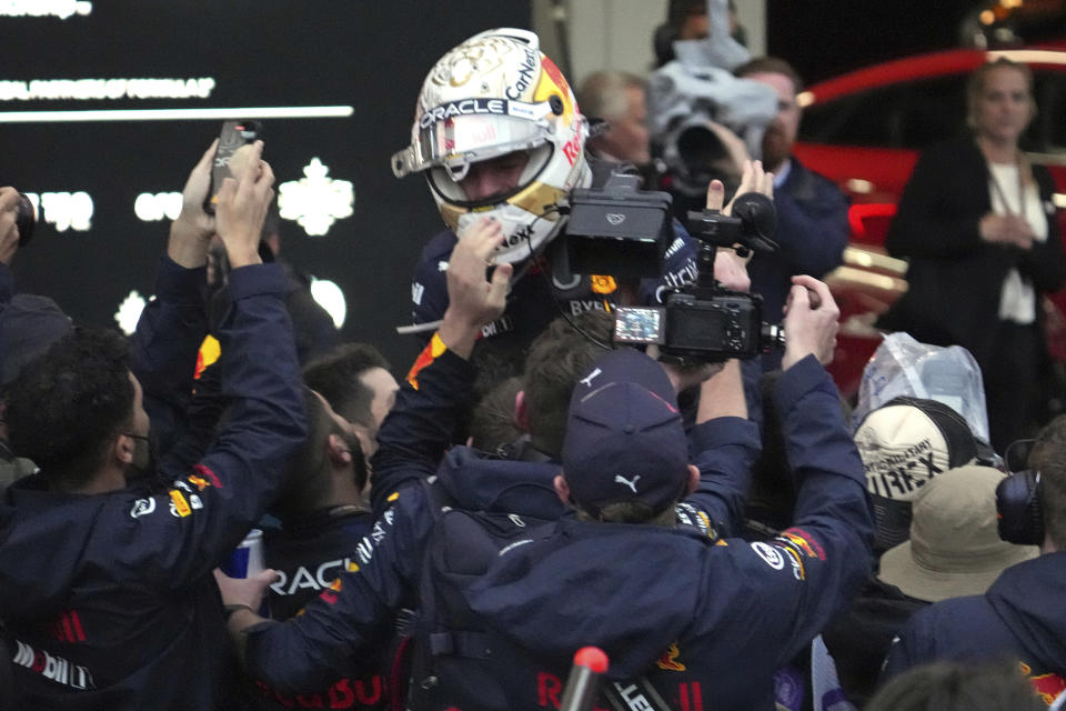 Red Bull driver Max Verstappen of the Netherlands celebrates with his team after winning the Japanese Formula One Grand Prix at the Suzuka Circuit in Suzuka, central Japan, Sunday, Oct. 9, 2022. Verstappen secured second consecutive Formula One drivers' championship. (AP Photo/Toru Hanai)