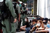 Anti-government demonstrators are detained by riot police during a lunch time protest as a second reading of a controversial national anthem law takes place in Hong Kong