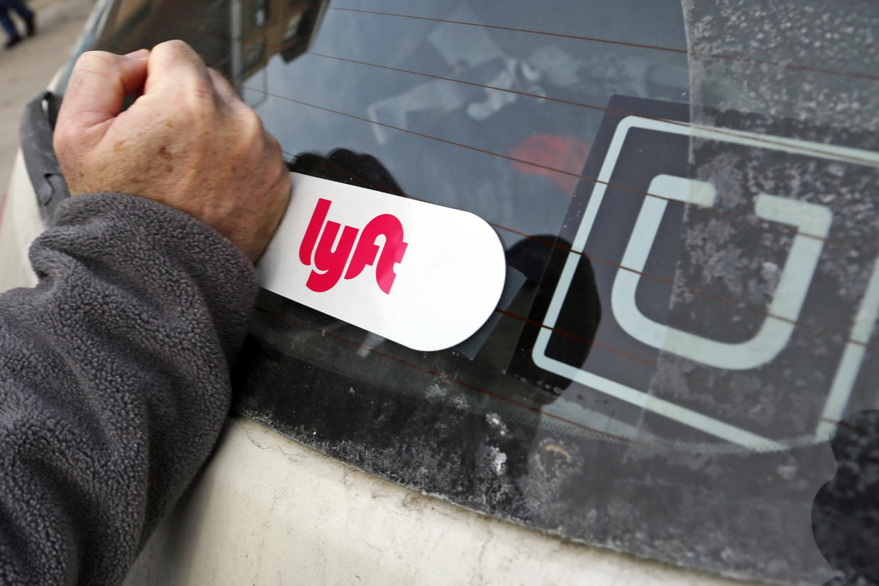 In this Jan. 31, 2018, photo, a Lyft logo is installed on a Lyft driver's car in Pittsburgh. (AP Photo/Gene J. Puskar)