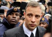 Olympic and Paralympic track star Oscar Pistorius leaves court after appearing for the 2013 killing of his girlfriend Reeva Steenkamp in the North Gauteng High Court in Pretoria, South Africa, June 14, 2016. REUTERS/Siphiwe Sibeko/Files