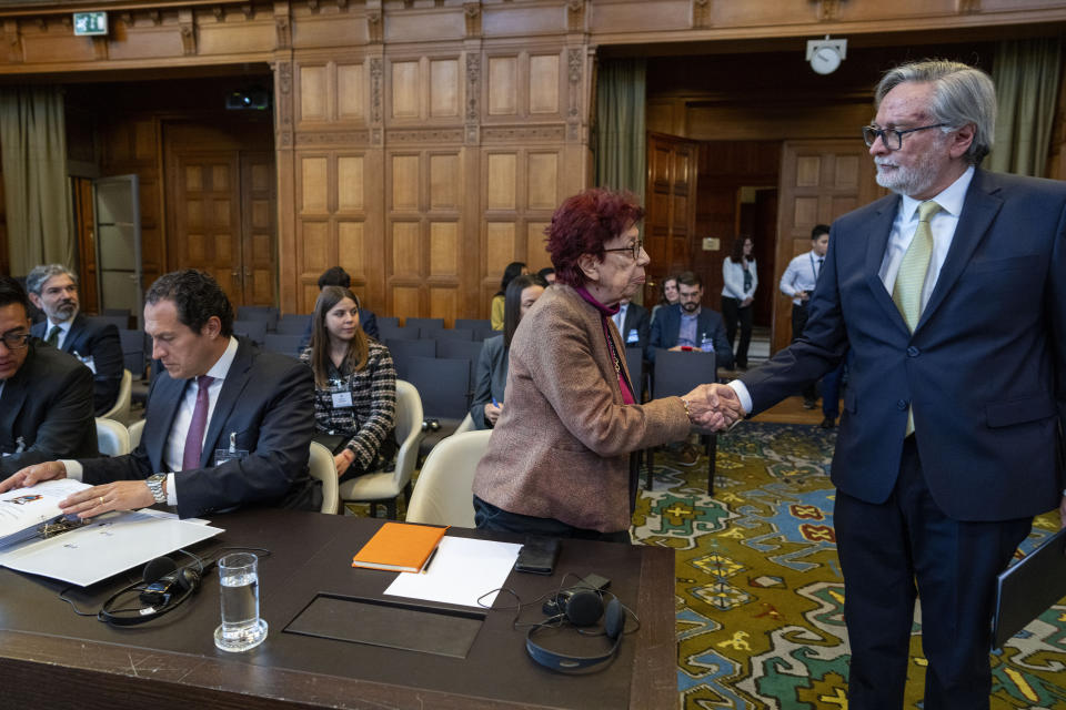 Ecuador's ambassador Andres Teran Parral, right, greets Mexico's agent and ambassador Carmen Moreno Toscano, center, and legal advisor of the Mexico Foreign Minister Alejandro Celorio Alcantara, left, at the International Court of Justice, or World Court, in The Hague, Netherlands, Wednesday, May 1, 2024. Mexico is taking Ecuador to the United Nations' top court on Tuesday accusing the nation of violating international law by storming into the Mexican embassy in Quito on April 5, and arresting former Ecuador Vice President Jorge Glas, who had been holed up there seeking asylum in Mexico. (AP Photo/Peter Dejong)