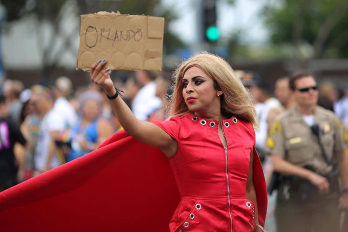 <p>A parade marcher holds a sign in memory of the victims of the attack on a gay night club in Orlando, Florida at the 46th annual Los Angeles Gay Pride Parade in West Hollywood, California, June 12, 2016. (REUTERS/David McNew) </p>