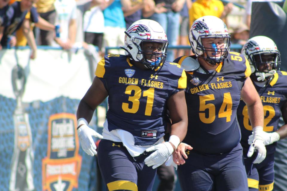 Kent State junior running back Bryan Bradford (left) and offensive lineman Sam Allan celebrate another successful running play during last season's win over VMI at Dix Stadium. The Flashes rushed for 494 yards against the Keydets.