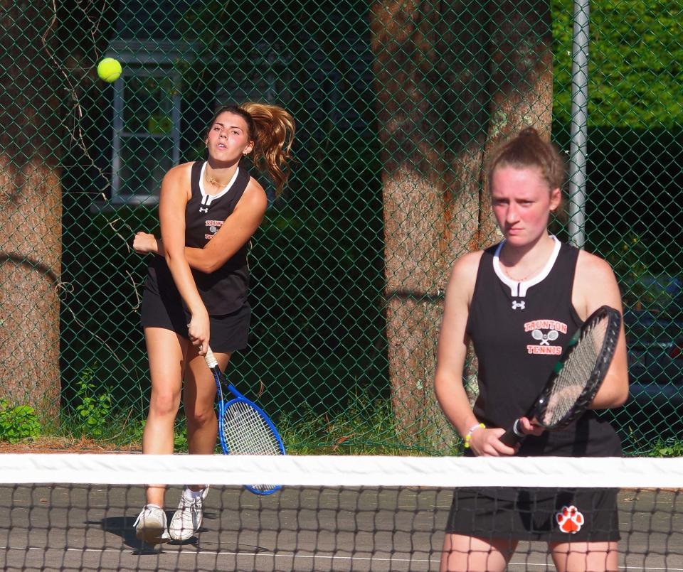 Taunton's Janelle Garcia hits a return as teammate Courtney Martin stands ready in the tourney tennis match against Bridgewater/Raynham on Tuesday, May 30, 2023.