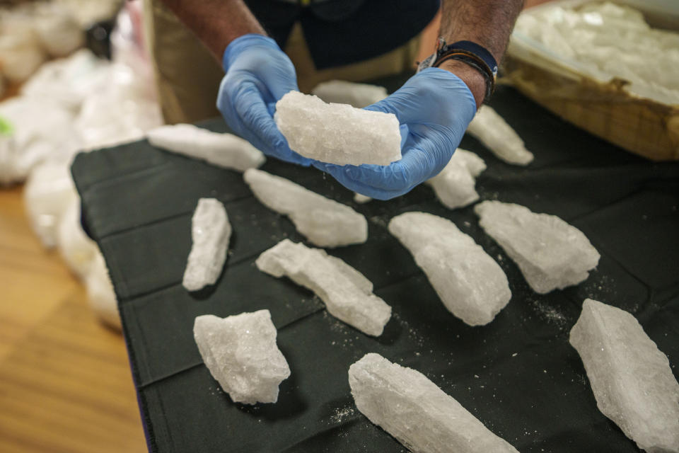 A police officer shows part of a haul of 1.8 tons of methamphetamine in Madrid, Spain, Thursday, May 16, 2024. Spanish police say they have dismantled a major methamphetamine distribution network of the Mexican Sinaloa cartel after making a bust of 1.8 tons of the illegal drug. (AP Photo/Manu Fernandez)
