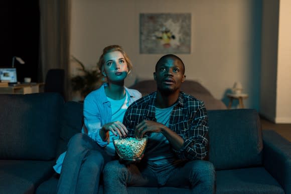 A young couple watching TV