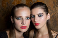 <p>It’s always been a rule not to wear dark makeup on the eyes and lips simultaneously, but at Carolina Herrera, these models proved that a red lip can be understated. (Photo: ImaxTree) </p>