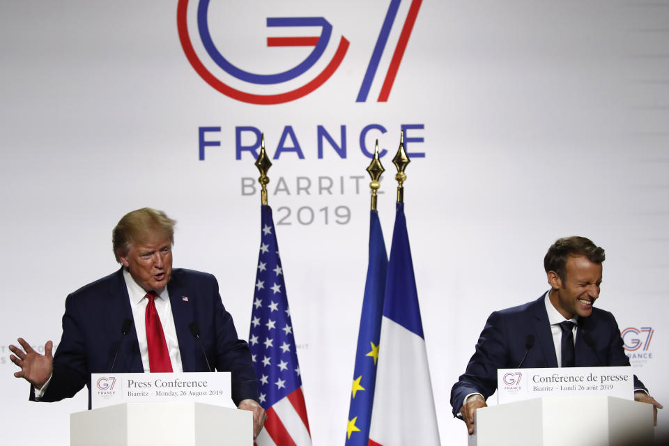 U.S President Donald Trump and French President Emmanuel Macron hug after their joint press conference at the G7 summit Monday, Aug. 26, 2019 in Biarritz, southwestern France. French president says he hopes for meeting between US President Trump and Iranian President Rouhani in coming weeks. (AP Photo/Francois Mori)