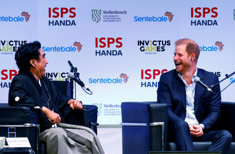 Britain's Prince Harry, Duke of Sussex, laughs while talking with ISPS HANDA’s founder Haruhisa Handa during a summit on the power of sport, community and philanthropy at the ISPS Sports Values Summit-Special Edition in Tokyo, Japan, August 9, 2023. REUTERS/Kim Kyung-Hoon