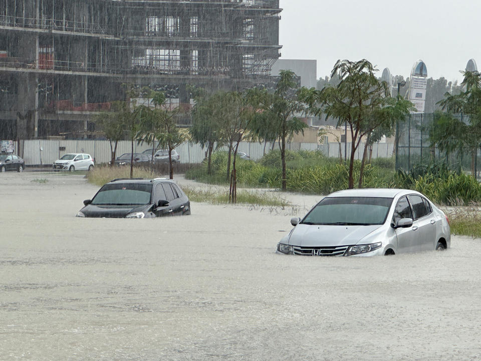Cars are seen abandoned on a flooded street in Dubai.