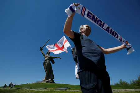 An England's fan poses in front of "The Motherland Calls" monument at the Mamayev Kurgan World War Two memorial complex in Volgograd, Russia June 18, 2018. REUTERS/Gleb Garanich