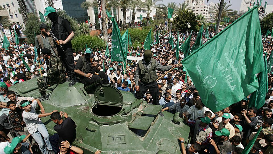 Palestinian Hamas members in Gaza City ride an armored vehicle seized from Fatah, a rival Palestinian political party, during a celebration rally in June 2007. - Abid Katib/Getty Images