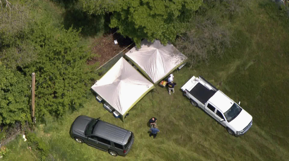 Police investigate a location in Logan, Utah, as they search for missing 5-year-old Elizabeth "Lizzy" Shelley on Wednesday, May 29, 2019. A body believed to be Lizzy was found later Wednesday less than a block from her home, bringing a wide-ranging search to a grim close five days after the child was taken from her home and killed by her uncle, police said. (John Wilson/The Deseret News via AP)