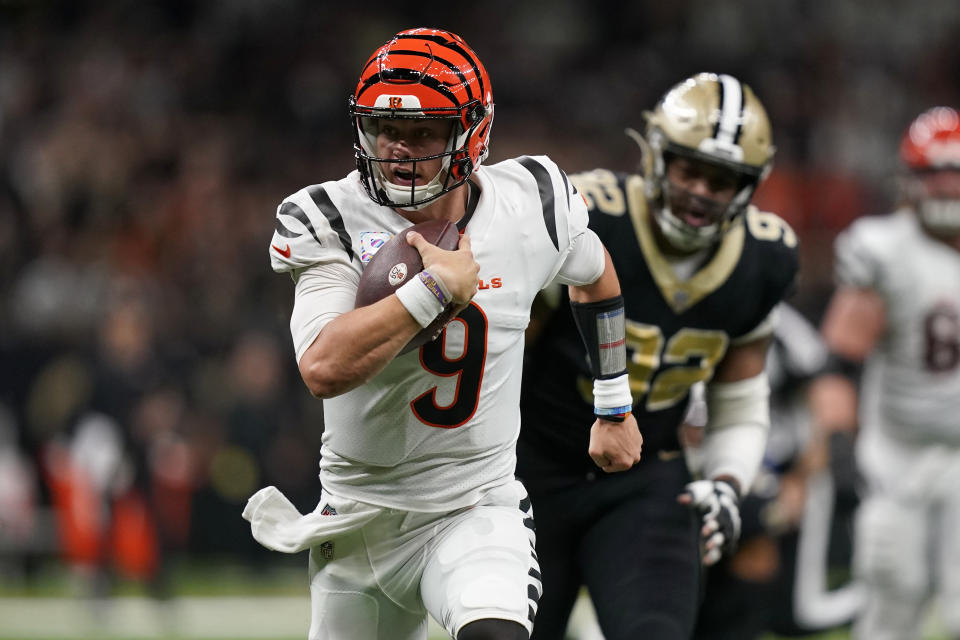 Cincinnati Bengals quarterback Joe Burrow (9) runs for a touchdown against the New Orleans Saints' Marcus Davenport (92) during the first half of an NFL football game in New Orleans, Sunday, Oct. 16, 2022. (AP Photo/Gerald Herbert)