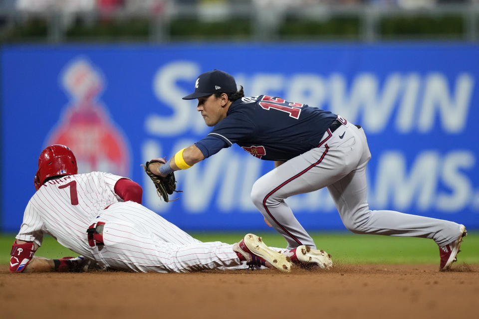 Philadelphia Phillies' Trea Turner, left, slides into second past Atlanta Braves second baseman Nicky Lopez after hitting a run-scoring double during the fourth inning of the second baseball game in a doubleheader, Monday, Sept. 11, 2023, in Philadelphia. (AP Photo/Matt Slocum)