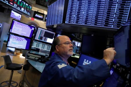 A trader works on the trading floor at the New York Stock Exchange (NYSE) at the opening of the market in New York City