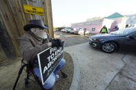 Mark Godbold, anti-abortion activist, holds a sign calling for prayer to end abortion, as he sits outside the entrance to the parking lot of the Jackson Women's Health Organization, a state-licensed abortion clinic in Jackson, Miss., Wednesday, Dec. 1, 2021. A small group of anti-abortion activists stood outside the clinic in an effort to dissuade patients from entering. On Wednesday, the U.S. Supreme Court hears a case that directly challenges the constitutional right to an abortion established nearly 50 years ago. (AP Photo/Rogelio V. Solis)