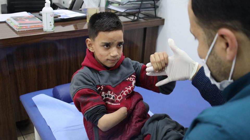 PHOTO: Abdelkader Madrati, 10, is prepped by a physical therapist before a session on March 19, 2024, at the Happy Steps Center in the city of Azaz, north of Aleppo, Syria.  (Abdul Razzaq Al-Shami/ABC News)