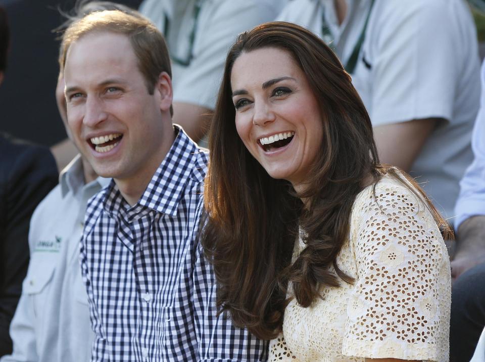 Britain's Prince William and his wife Catherine, Duchess of Cambridge, react as they watch an animal show during a visit to Taronga Zoo in Sydney in this file photograph dated April 20, 2014. Prince William and his wife Kate are expecting their second baby, Buckingham Palace said on September 8, 2014. REUTERS/Phil Noble/files (AUSTRALIA - Tags: ROYALS SOCIETY ENTERTAINMENT TPX IMAGES OF THE DAY)