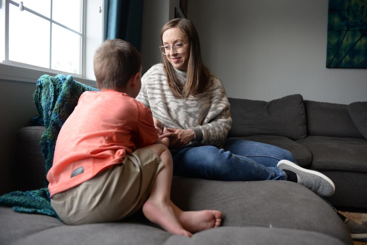 Sarah MacDonald's son was hospitalized during the E. coli outbreak in Calgary last September. She says she still has questions about how such a large and devastating outbreak could have occurred and wants to know what is going to change.  (Helen Pike/CBC - image credit)