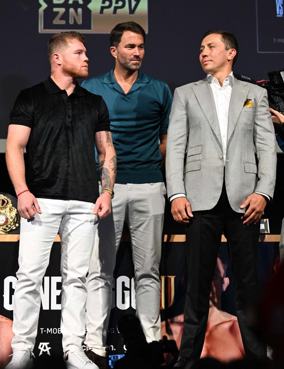 Canelo Alvarez, left, and Gennadiy Golovkin stare each other down while they pose for photos during a press conference ahead of their September fight.