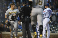 Pittsburgh Pirates' Daniel Vogelbach left, is held back after colliding with Chicago Cubs catcher Willson Contreras at home plate during the fourth inning of a baseball game Tuesday, May 17, 2022, in Chicago. (AP Photo/Paul Beaty)