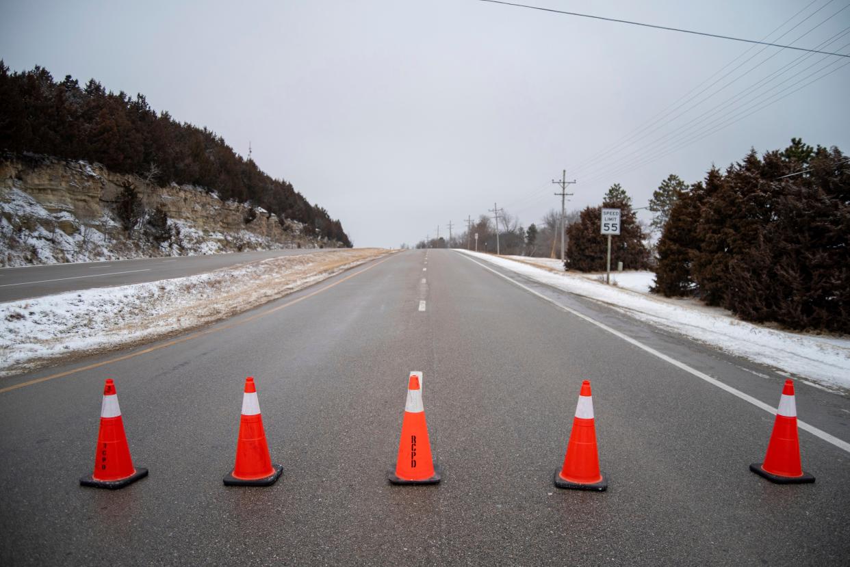 Tuttle Creek Boulevard is closed off starting at the Marlatt Avenue intersection in Manhattan, Kansas, Friday, Jan. 24, 2020. A snowplow struck and killed two pedestrians in Kansas before sunrise Friday after a winter storm coated parts of the Midwest with snow.  (Nickolas Oatley/The Manhattan Mercury via AP)