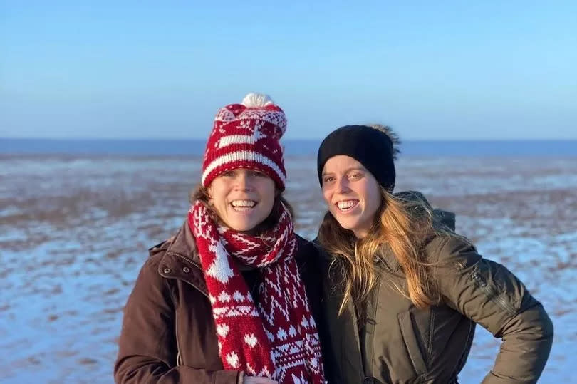 Eugenie and Beatrice on a windy beach