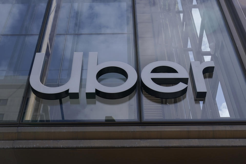 FILE - An Uber sign is displayed at the company's headquarters in San Francisco, Monday, Sept. 12, 2022. The future of Uber and Lyft in Minneapolis has been a source of concern and debate in recent weeks after the City Council voted last month to require that ride-hailing companies pay drivers a higher rate while they are within city limits. (AP Photo/Jeff Chiu, File)