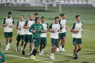 Players warm up during a training session of Mexico's national soccer team in Jor, Qatar, Sunday, Nov. 27, 2022. (AP Photo/Moises Castillo)