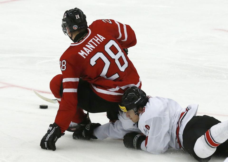 Canada's Anthony Mantha (L) is hauled down on a break-away by Switzerland's Samuel Kreis during the second period of their IIHF World Junior Championship ice hockey game in Malmo