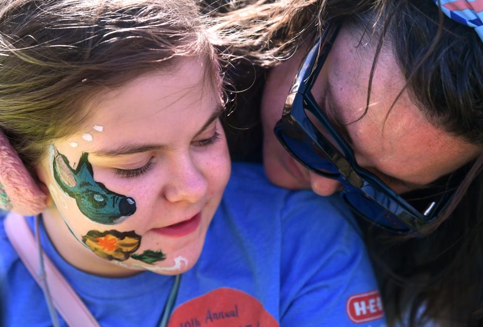 Loralei Jurkis, 10, listens to her mother Marissa as she gets a face painting Saturday. Hardin-Simmons University’s Autism Acceptance Celebration was a free community event celebrating neurodiversity.