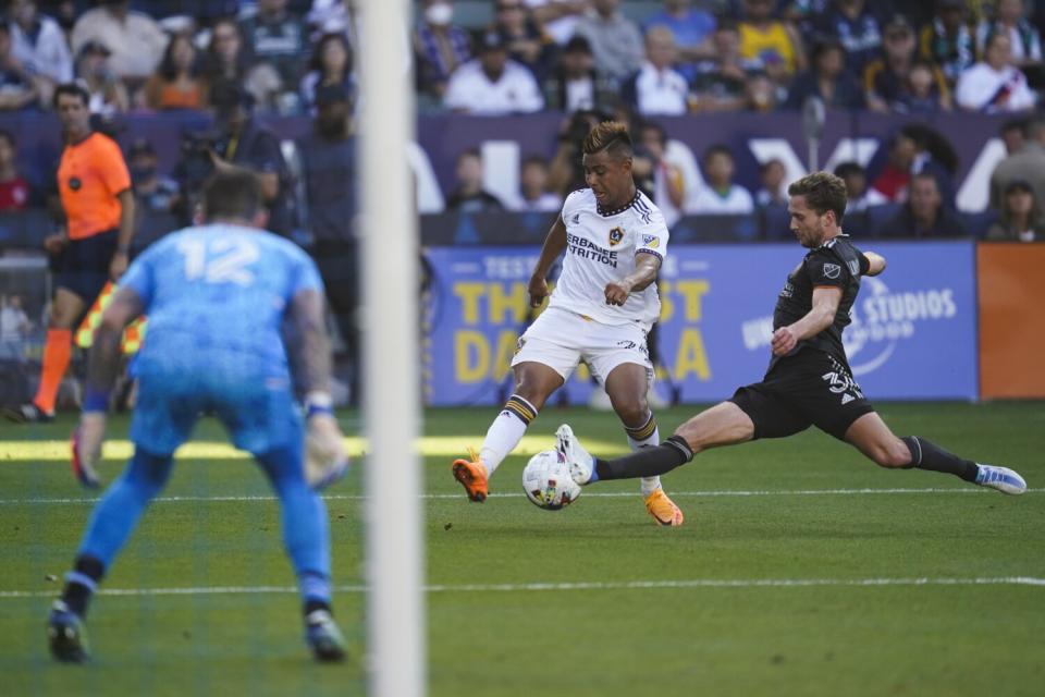 Houston Dynamo defender Adam Lundqvist deflects a shot by Galaxy midfielder Efrain Alvarez.